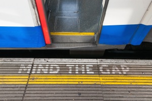 Mind The Gap Sign With Open Train Door