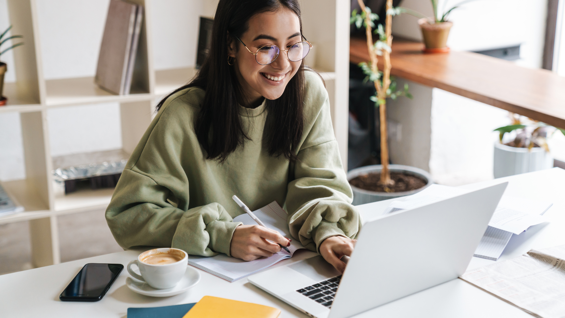 high school student writing personal insight questions on her laptop for the California University system